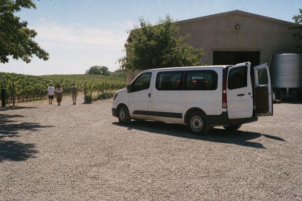Small group van parked at a Seneca Lake winery, no text, no logos, no people