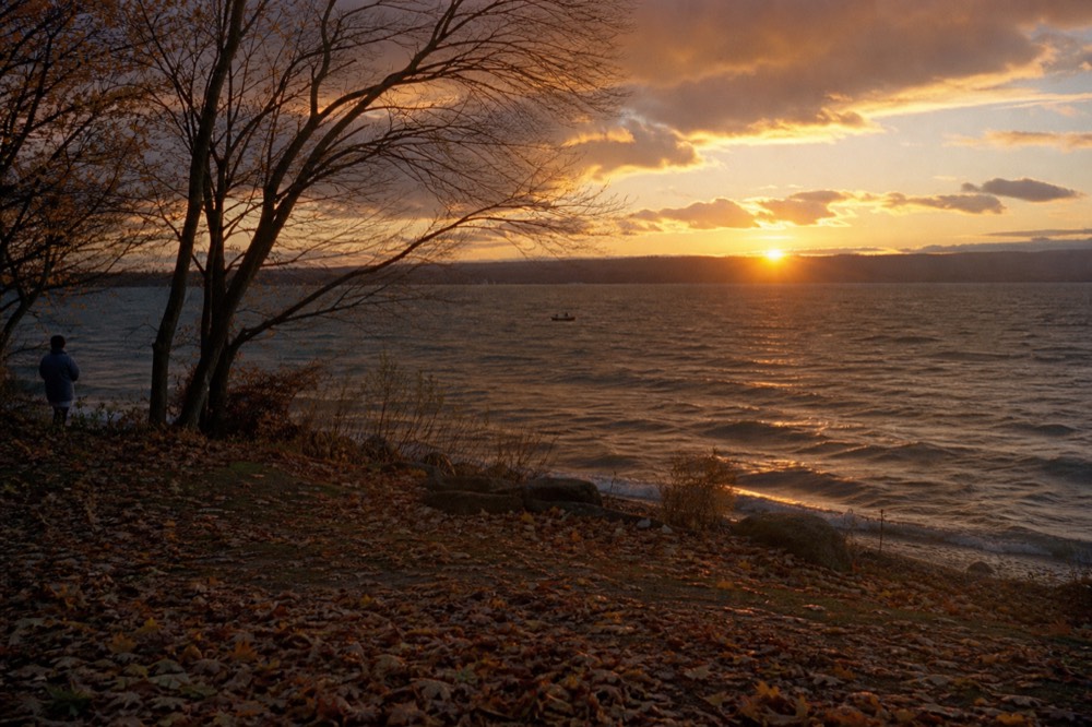 Sunset over Seneca Lake with a boat in the distance, no text, no logos, no people