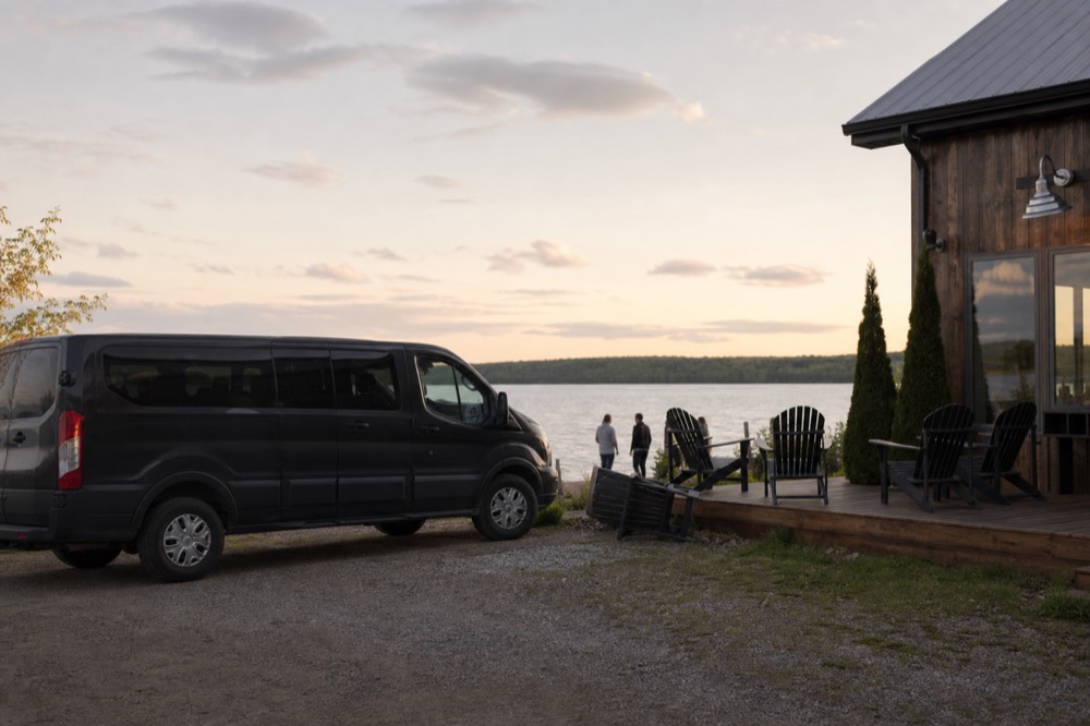 A passenger van parked outside a Seneca Lake winery tasting room, no text, no logos, no people