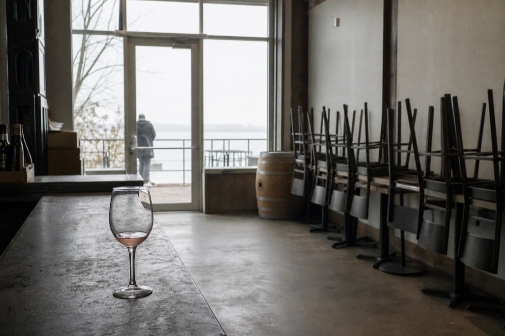 A quiet empty tasting room with lake views in the off-season, no text, no logos, no people