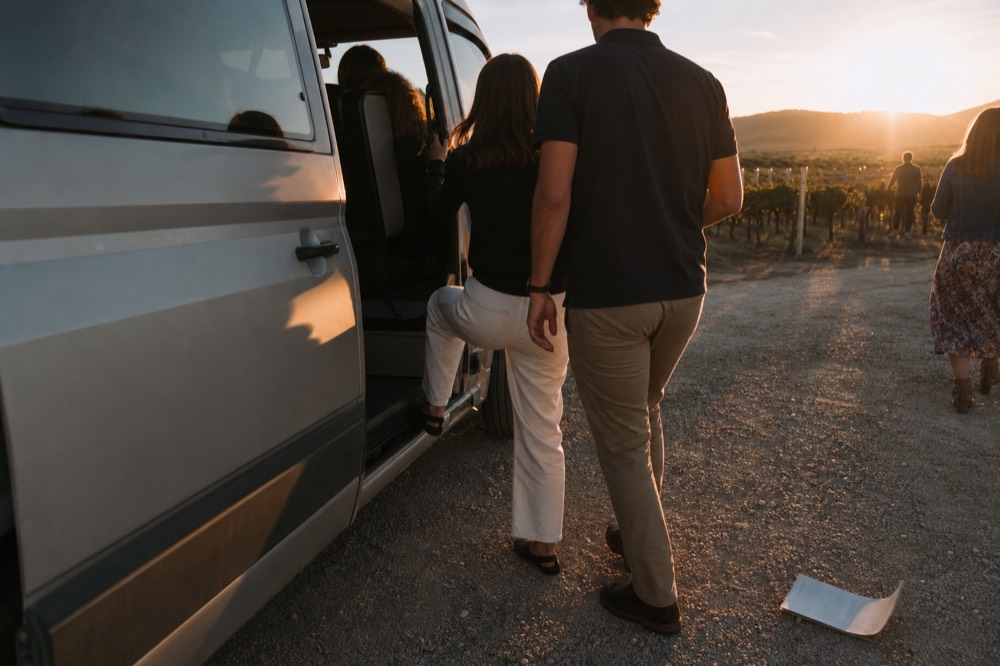 A couple boarding a wine tour van, no text, no logos, no people