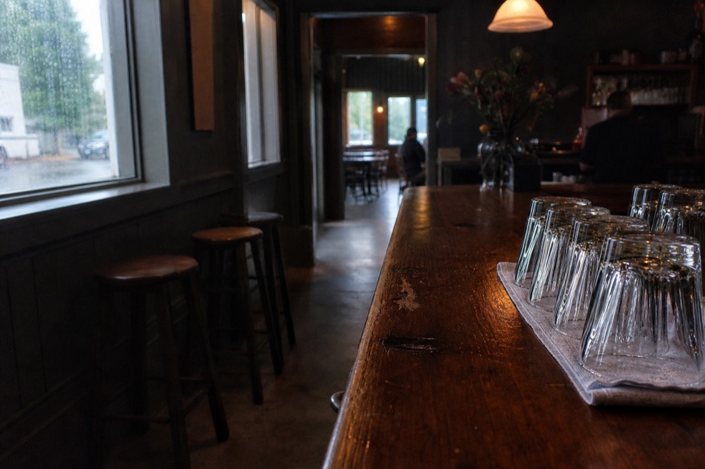 A tasting room bar with ID check sign, no text, no logos, no people