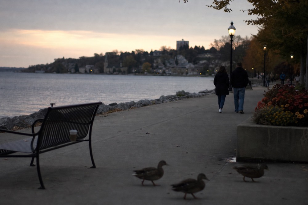 A lakefront promenade at the north end of a Finger Lake at dusk, no text, no logos, no people